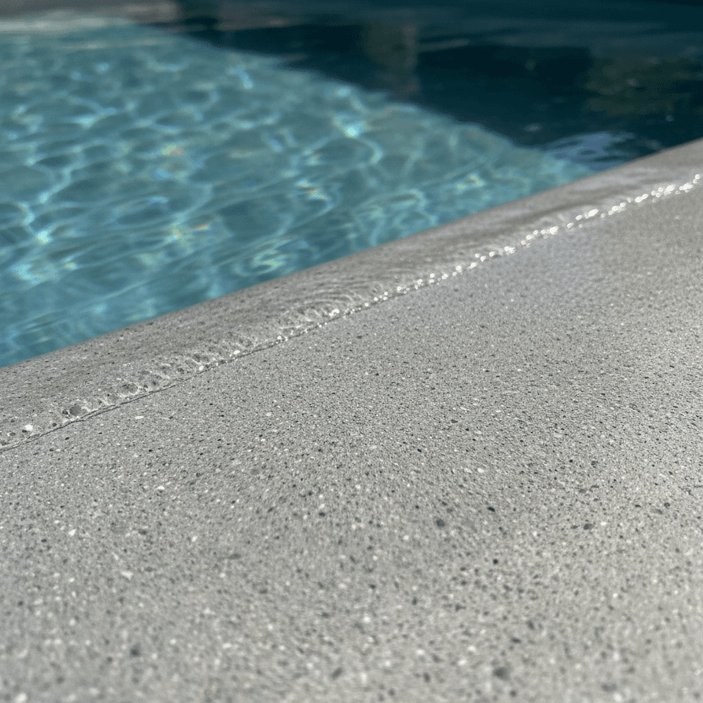 Close-up detail of finished gunite pool surface and water quality